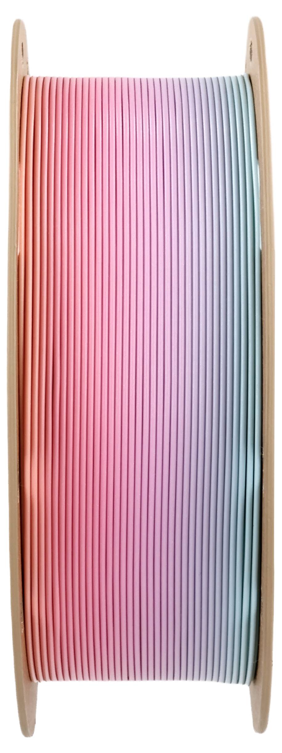 Spool with multicolored filament from pink through purple to blue, used for 3D printing.