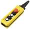 A yellow industrial remote control with three black buttons, one white button, and a red emergency stop button, used for machinery operation.