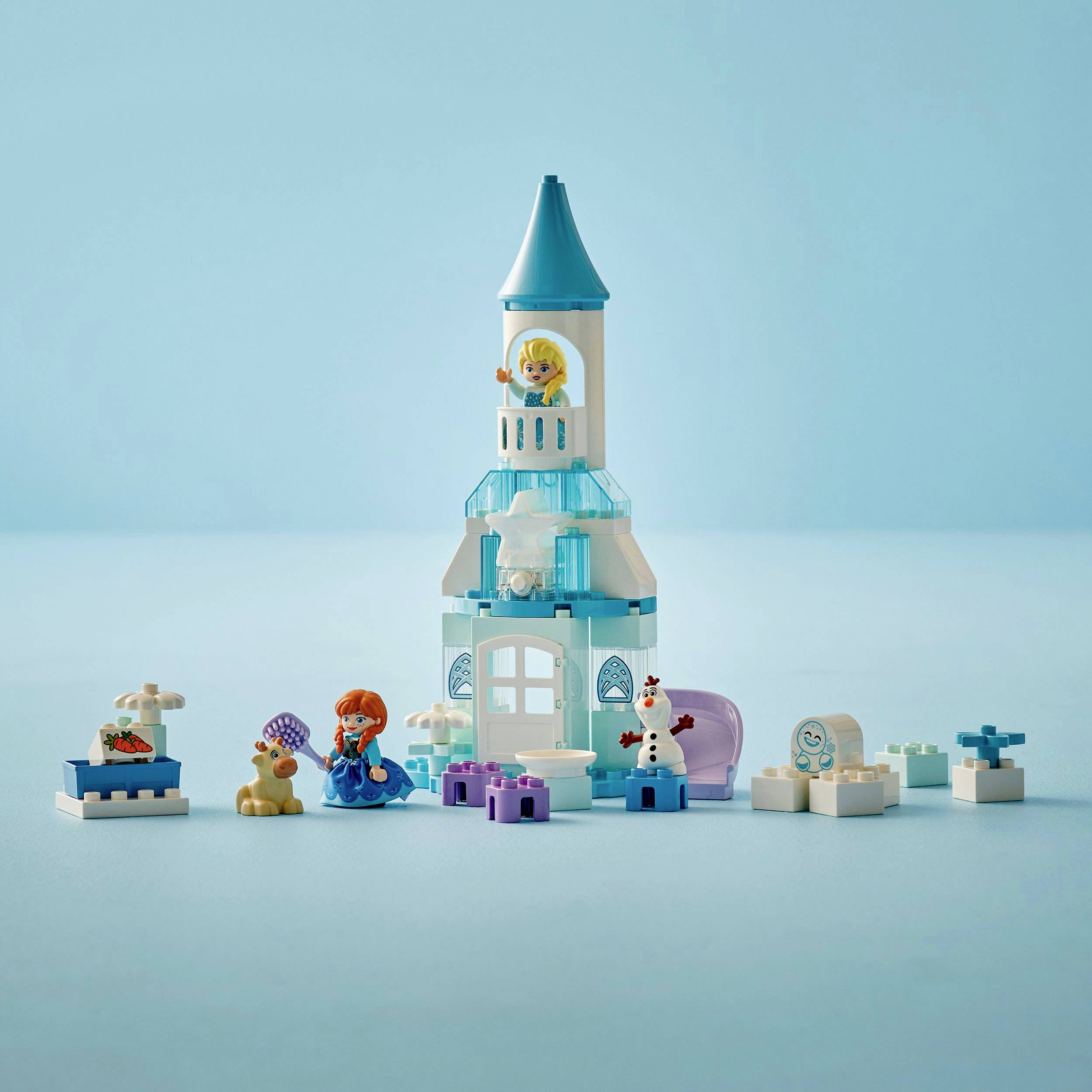 A toy ice tower with figures and accessories in the foreground. Main characters include a doll with orange hair and a small snowman.