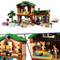 A colorful toy scene shows a two-story house with multiple figures, pets, and furniture, depicting a lively family environment.