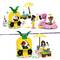 A Lego scene: Two children playing with a pink flamingo ride and a beach bar with pineapple decor. In the background, a yellow beach umbrella.