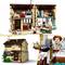 Toy house made of small building blocks with multiple rooms, figures playing and cooking. Richly detailed with furniture.