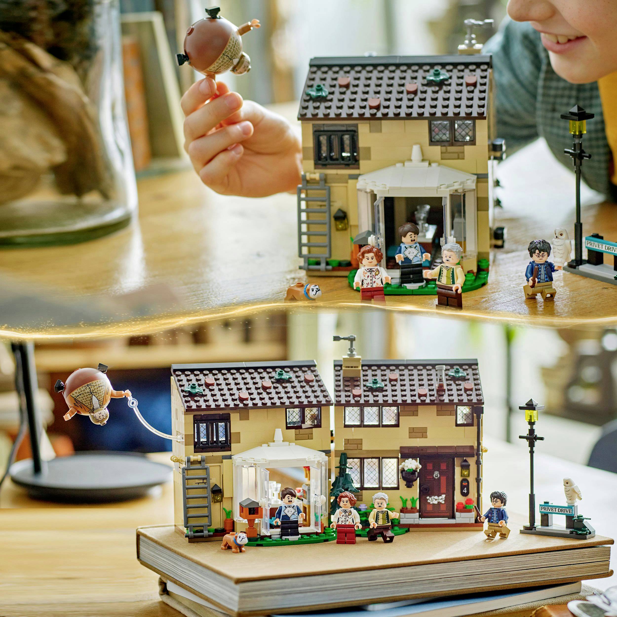 A model house with figures shows a scene from a film. A person lifts up a figure that hovers in the air.
