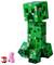 Large green and black Lego figure in the shape of a Creeper from the game 'Minecraft', next to it a small pig and a TNT block.