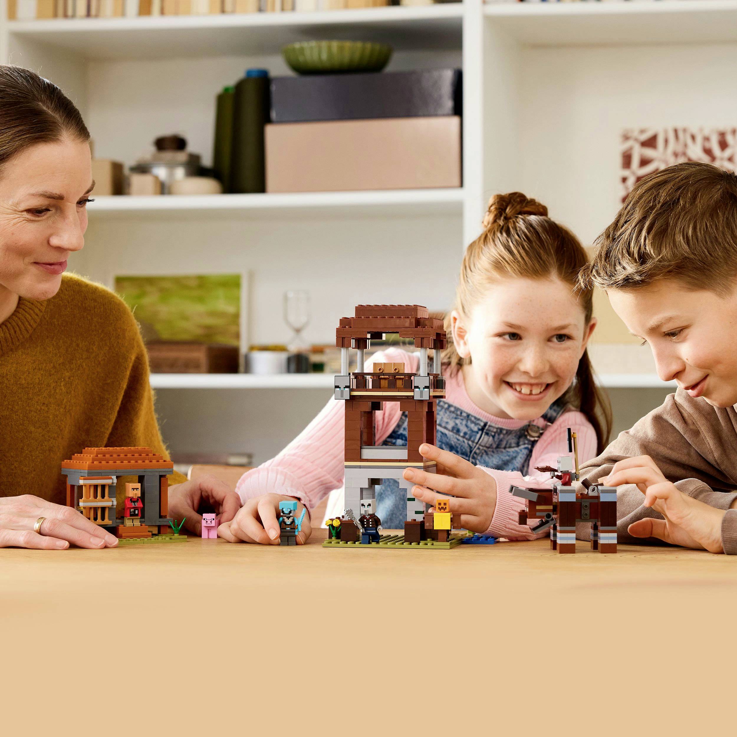 A woman and two children are building a structure together with colorful building blocks on a table. They are in a living room.