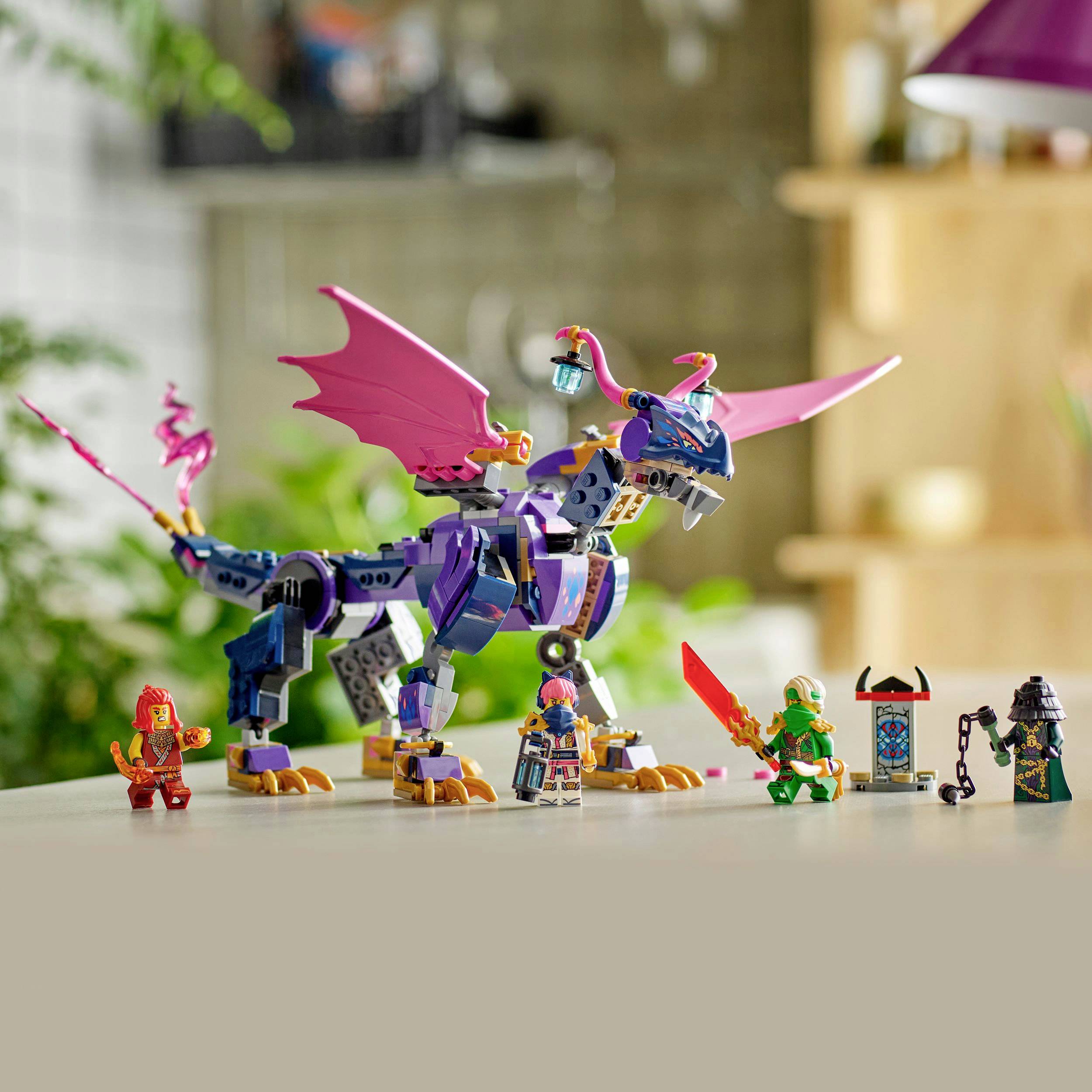 A purple dragon made of building blocks with movable wings and a saddle stands on a table. Figures in armor stand next to it.