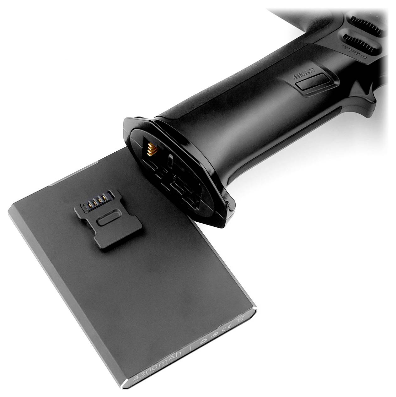 A black battery-powered handle is shown, partially disconnected from a removed, rectangular battery that may be about to be charged.