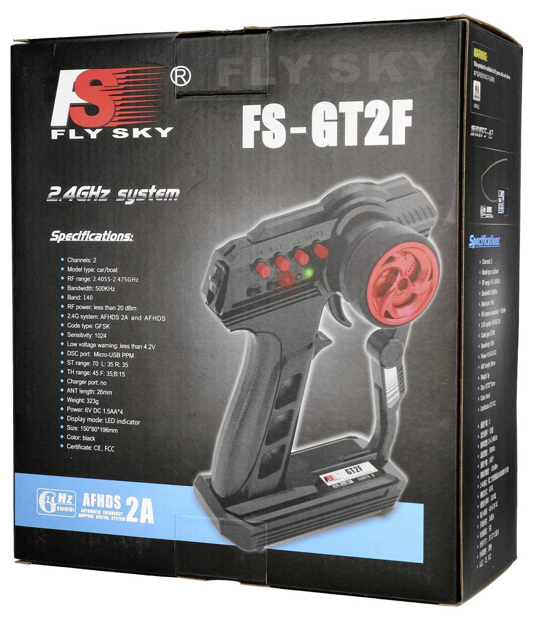 A black remote control with a red rotary dial, brand 'Fly Sky', model 'FS-GT2F', for 2.4GHz systems, with technical specification list.