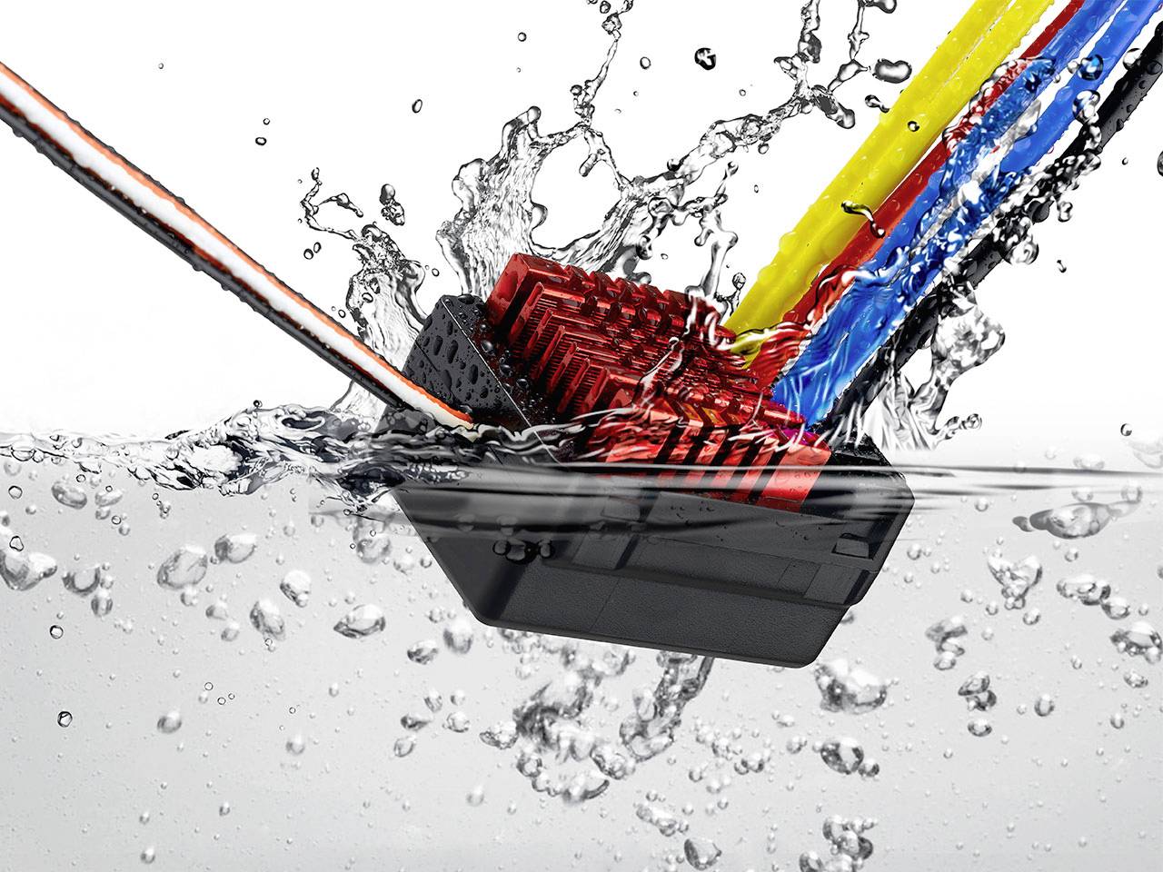 A black and red electronic device submerges in water, surrounded by splashing water and colourful cables.