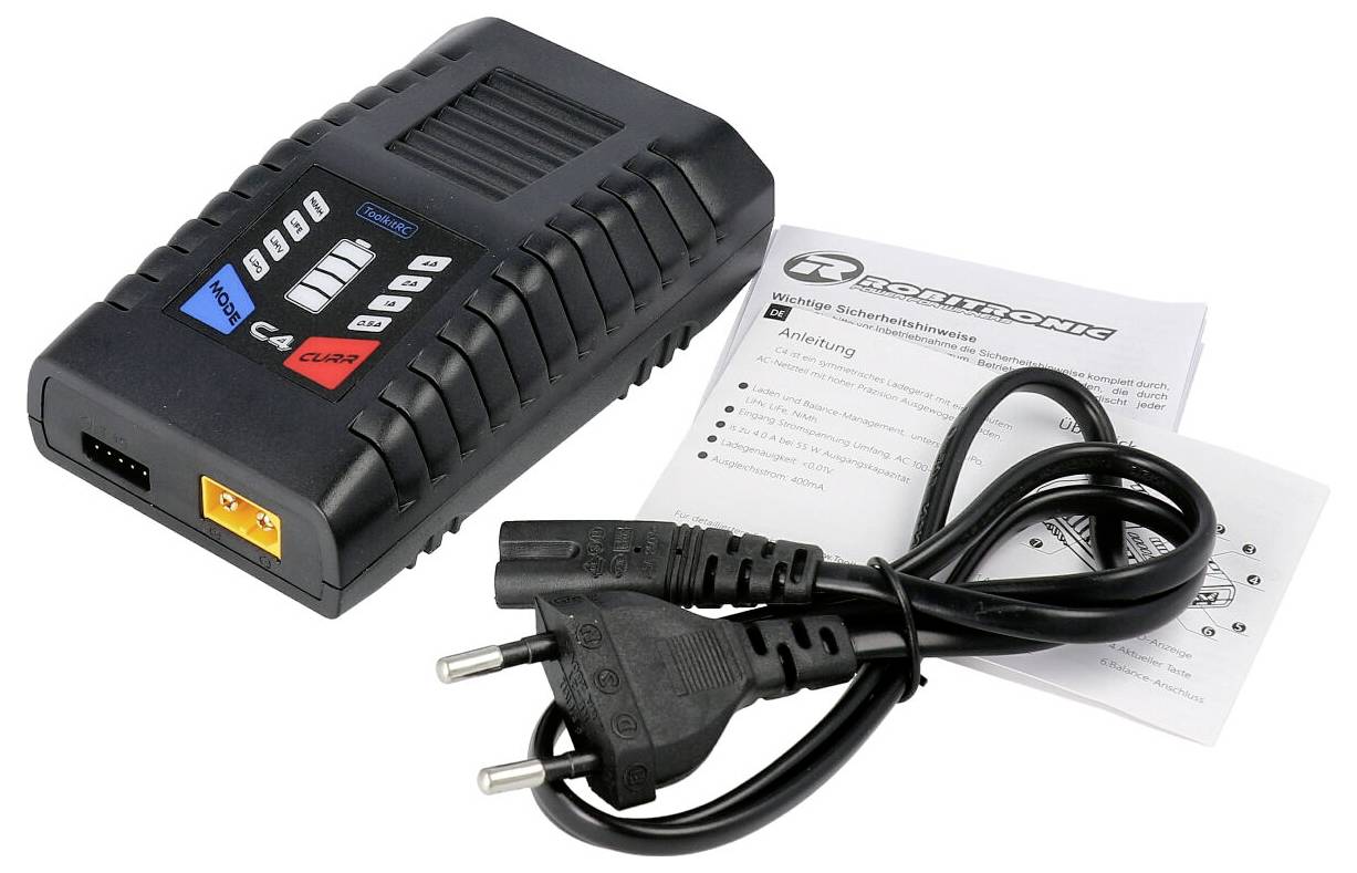 A black multi-port charger and a power cable are lying next to an instruction manual on a white background.