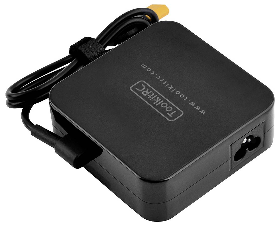 A black laptop charger with cable and the inscription 'TOOKERCG'. Connectors visible.