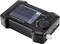 Black handheld device with display, showing graphical values and data. A rotary knob and two buttons ('EXIT' and 'OK') are visible.