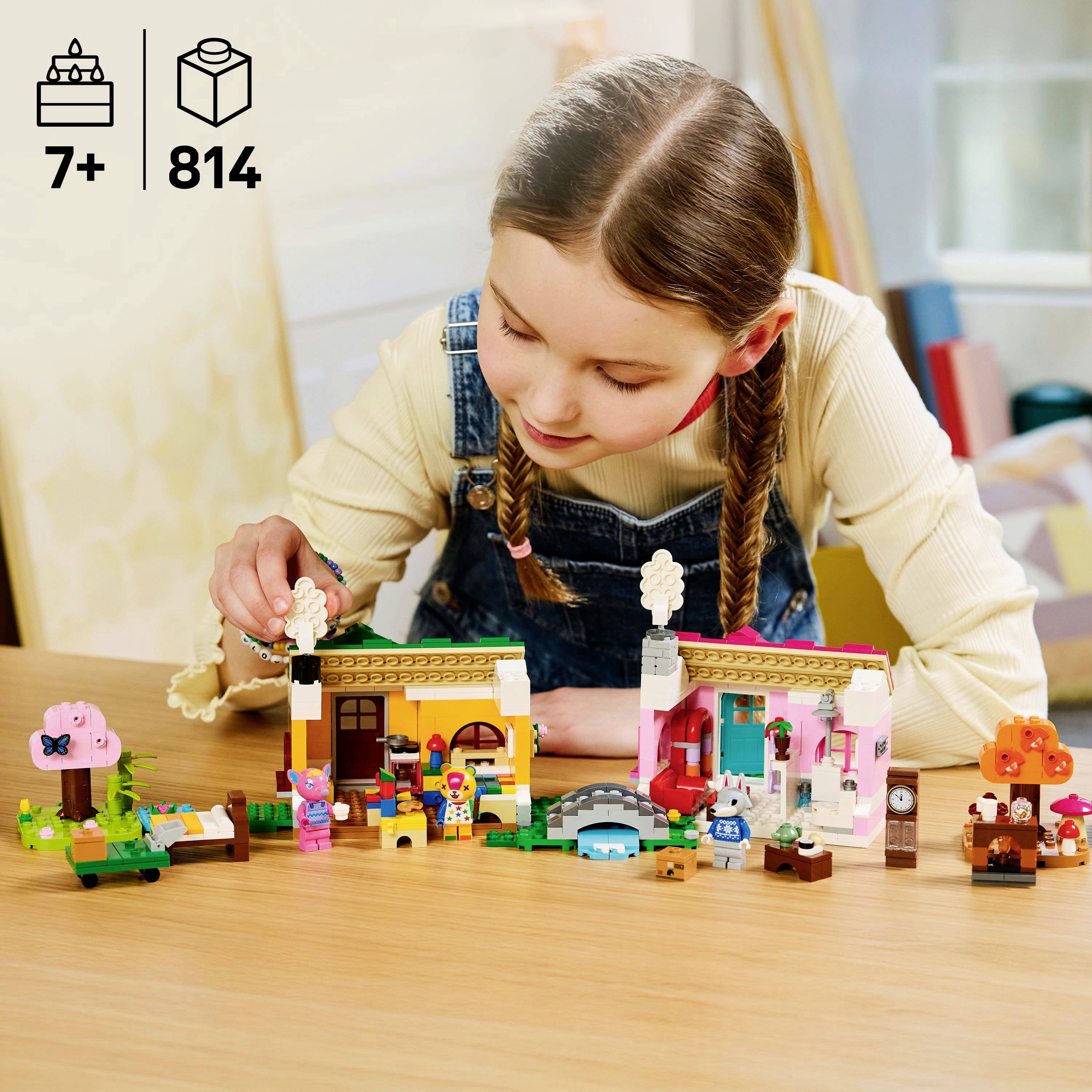A young girl plays with a miniature LEGO set featuring colorful houses and trees. The set is suitable for ages 7 and up.