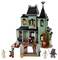 A detailed LEGO haunted house with spooky characters including a ghost, vampire, werewolf, skeleton, and Frankenstein's monster outside.
