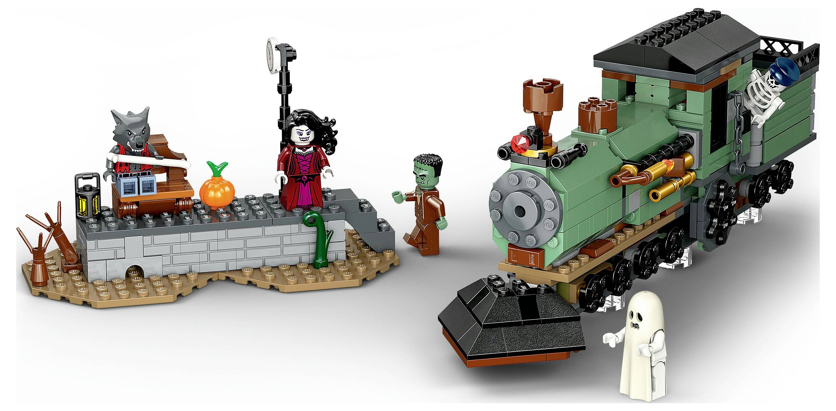 A Halloween-themed LEGO set featuring a ghost, a witch, a zombie, and a skeleton on a train. A pumpkin sits on a small platform.