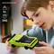 A child playing with a green toy car resembling a Dodge. Age recommendation: 9+. Set contains 392 pieces.