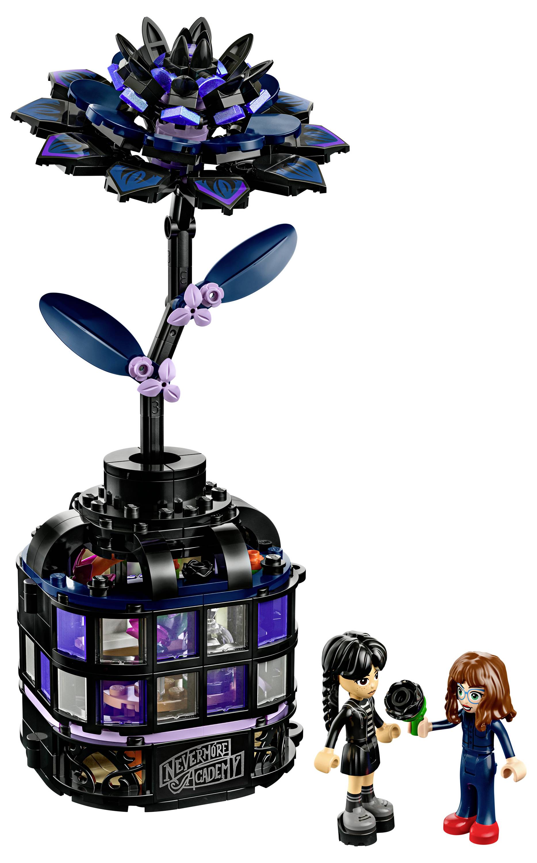 A LEGO building set featuring a large black and purple mystical plant with two mini-figures standing below, depicting a scene of fantasy or learning.
