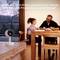 A family sits at a table in the background. In the foreground is a surveillance camera. Text: 'With Netatmo Smart Privacy, you protect your home without compromising your privacy.'