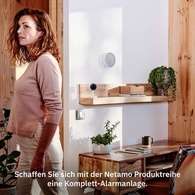 Woman stands in modern room, with Netatmo devices on shelf; text: 'Create a complete system with the Netatmo product range'.