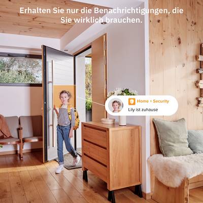 A child enters a modern, bright home. A digital notification announces: 'Lily is home'.