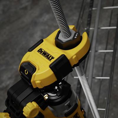 A yellow power tool is gripping a grey metal pipe. The machine bears the 'Dewalt' logo. Metal shelving is visible in the background.
