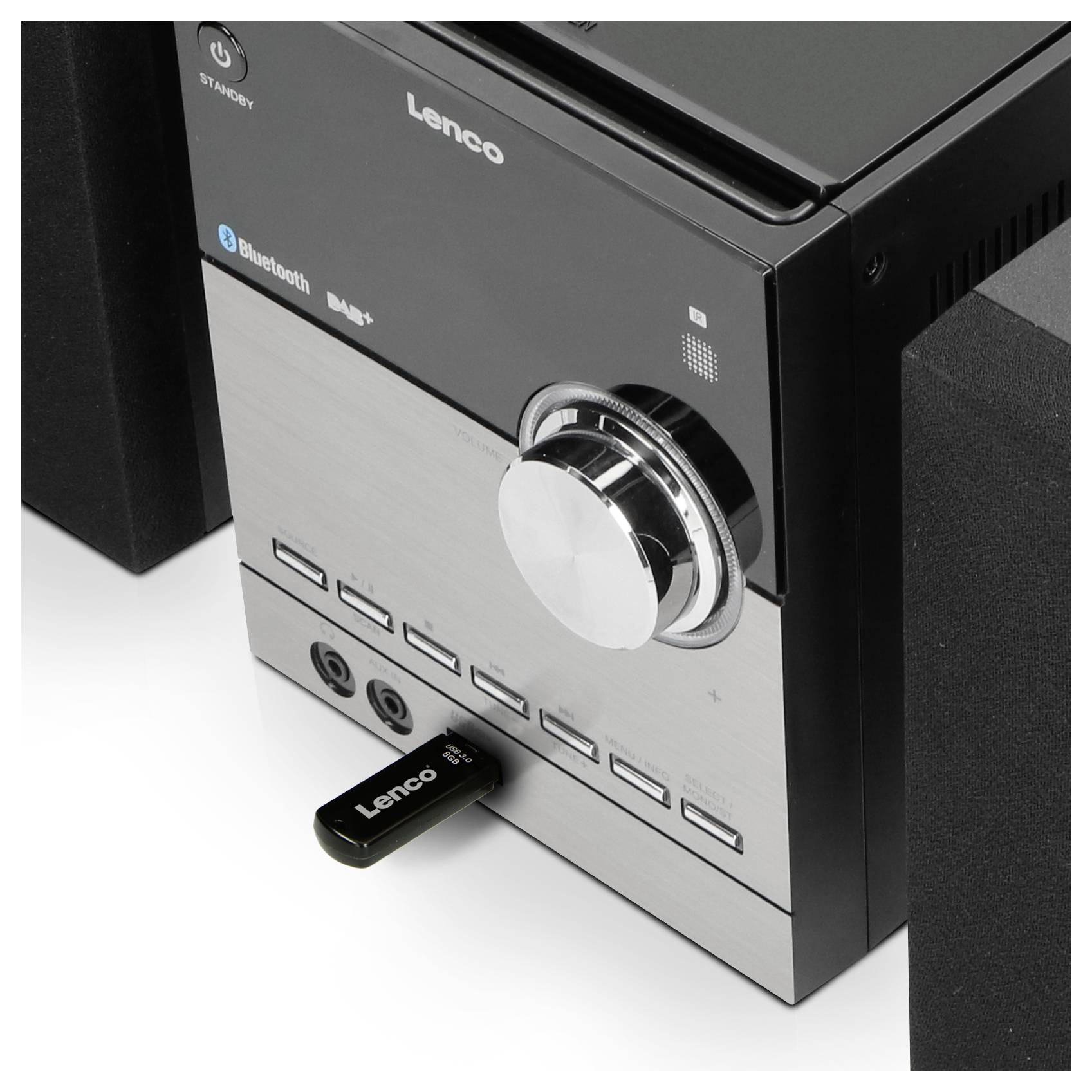 The image depicts a Lenco stereo system with a large volume control dial and a USB stick plugged into the front USB port.