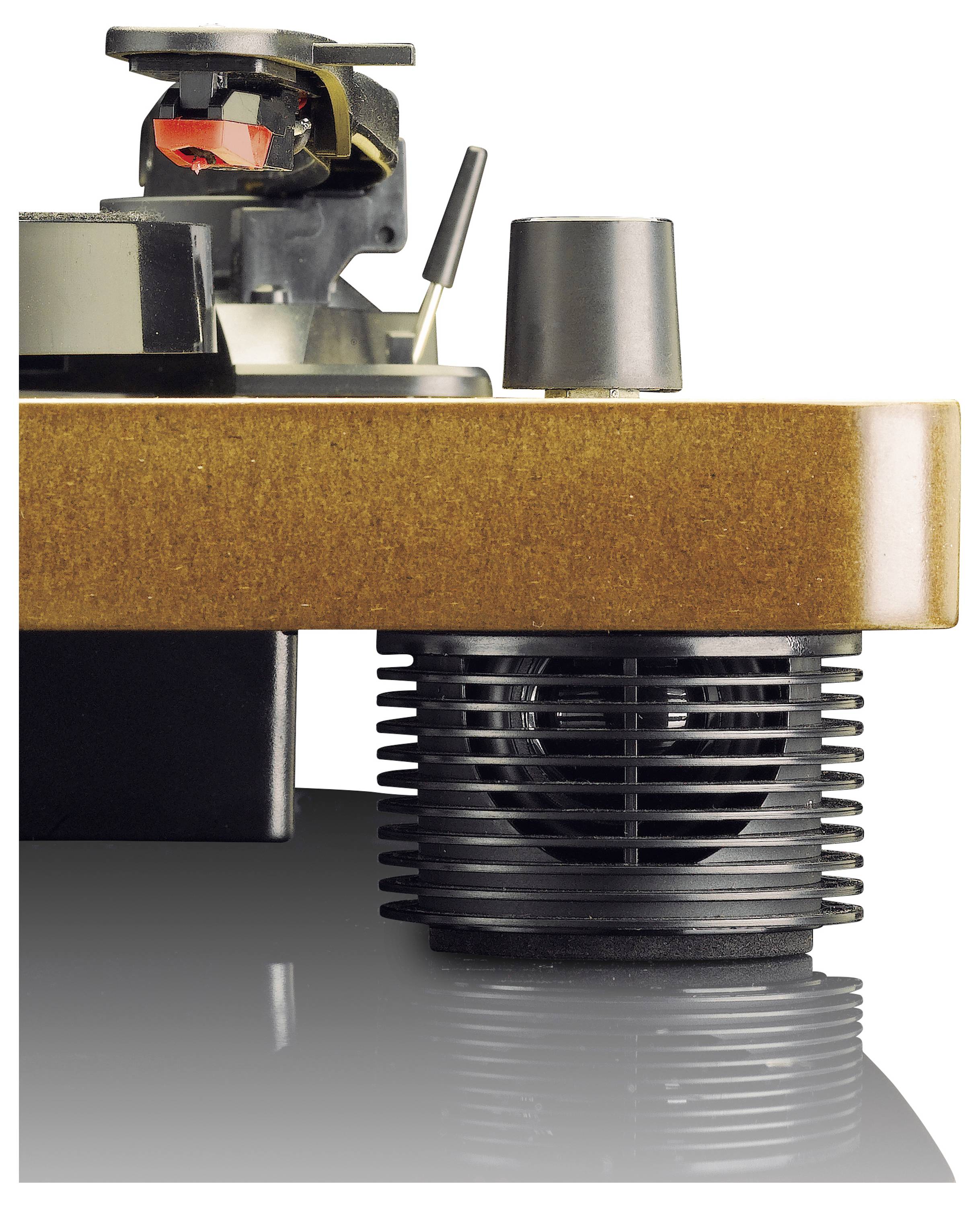 A turntable with tonearm and beige base. Part of a speaker is visible in the background.