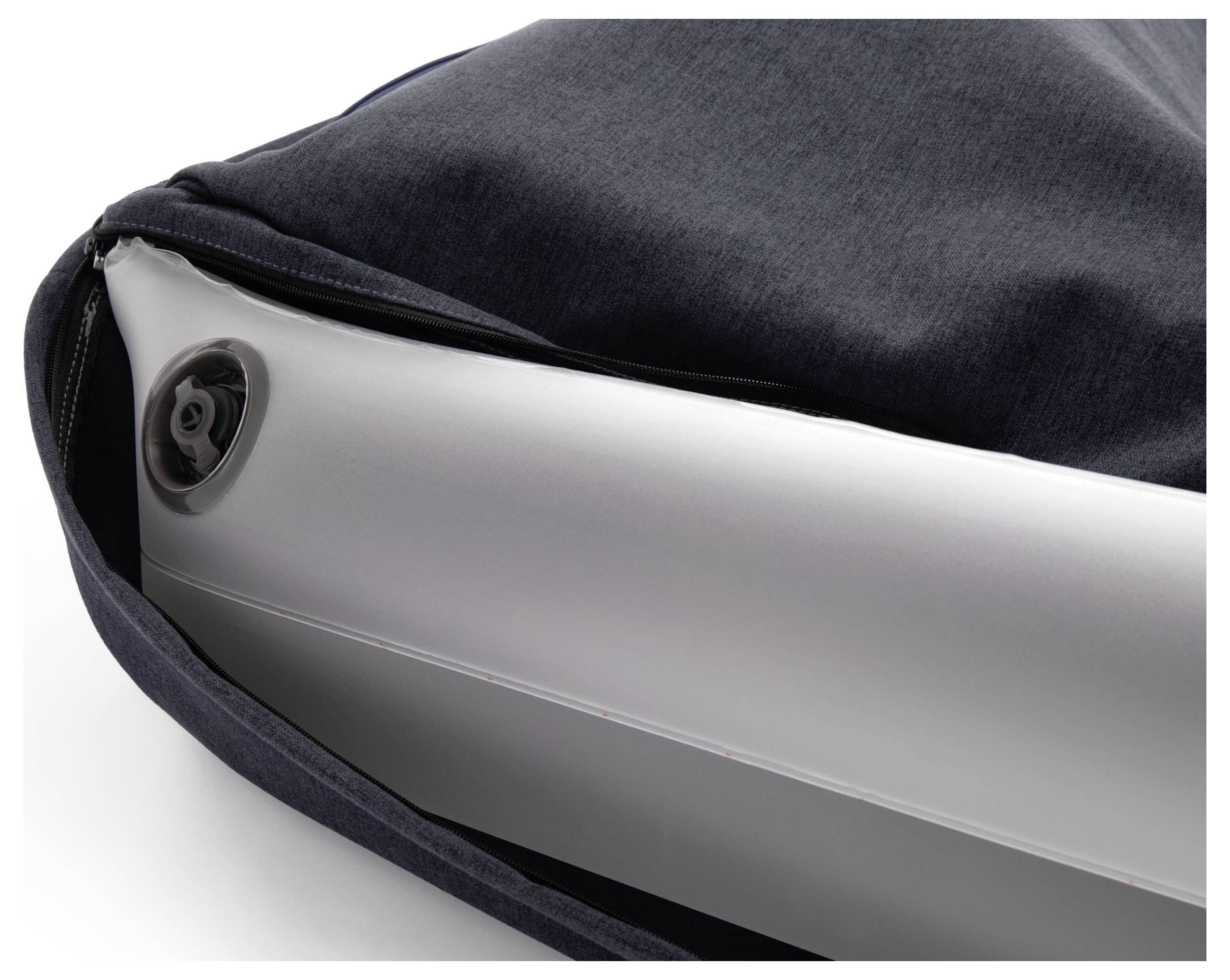 A white inflatable object partially encased in a dark grey fabric cover. Valve visible on the top surface.