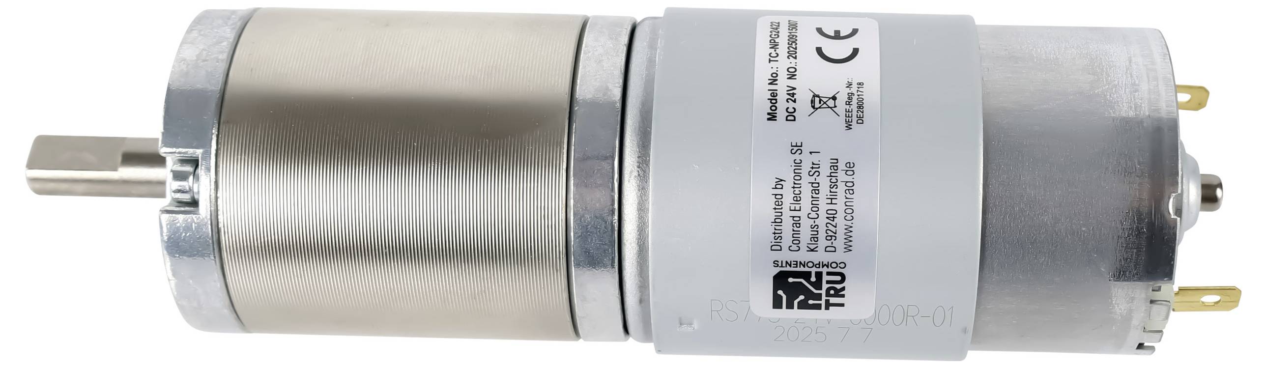 A small electric motor with a cylindrical metal body and label indicating technical specifications and compliance certifications.