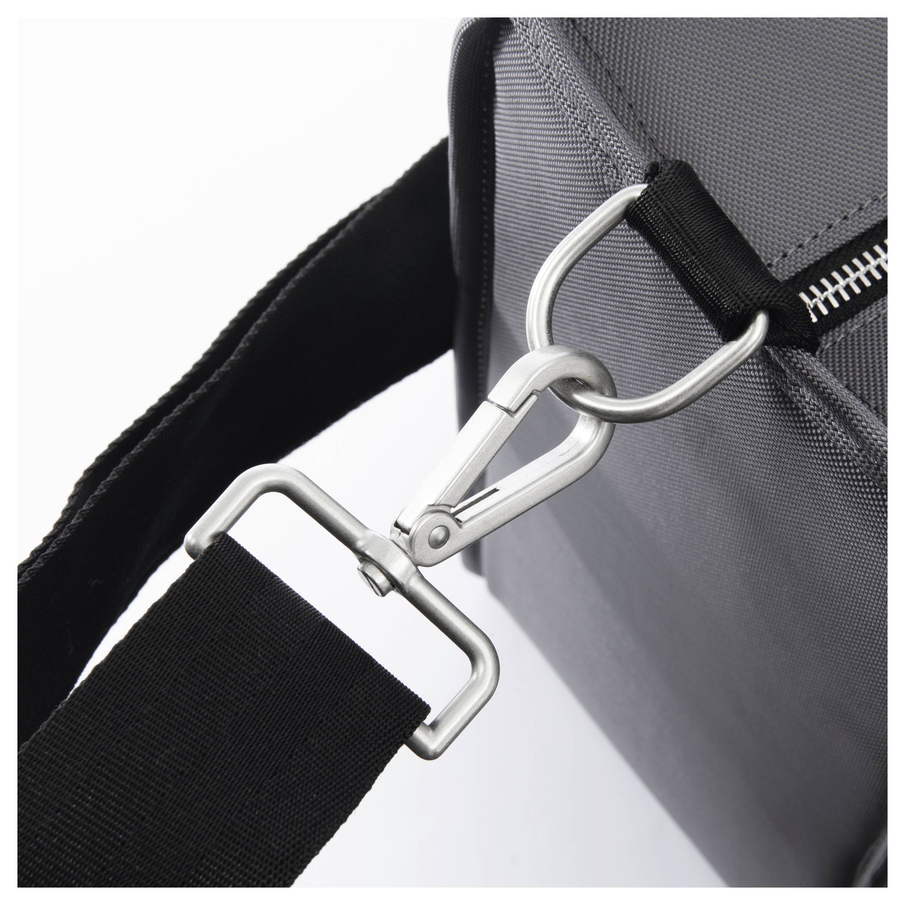 A black bag with a metal carabiner attached to a sturdy, adjustable shoulder strap.