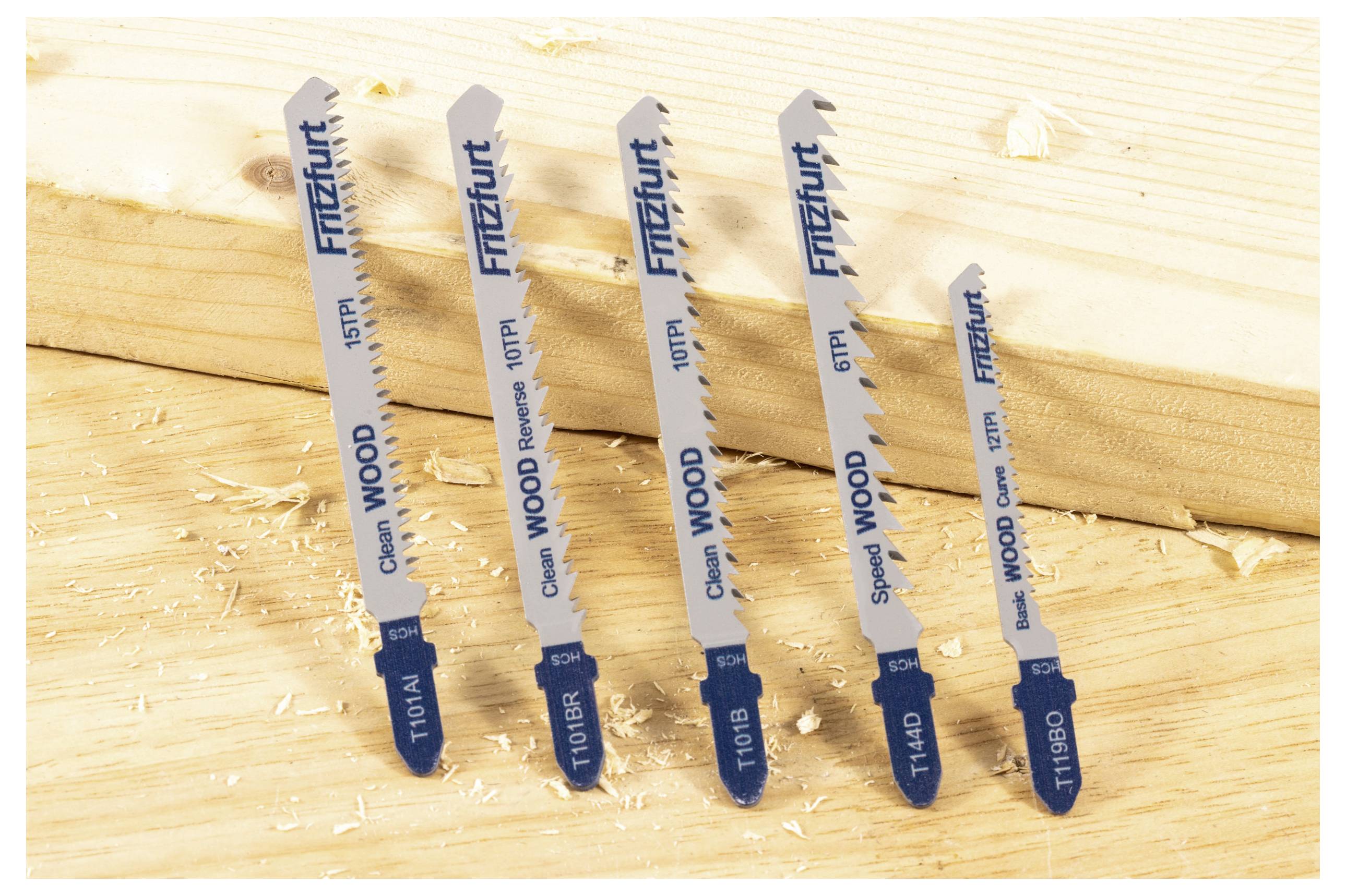'Five jigsaw blades labeled with various wood-cutting specifications are displayed on a wooden workbench, highlighting different cutting types.'