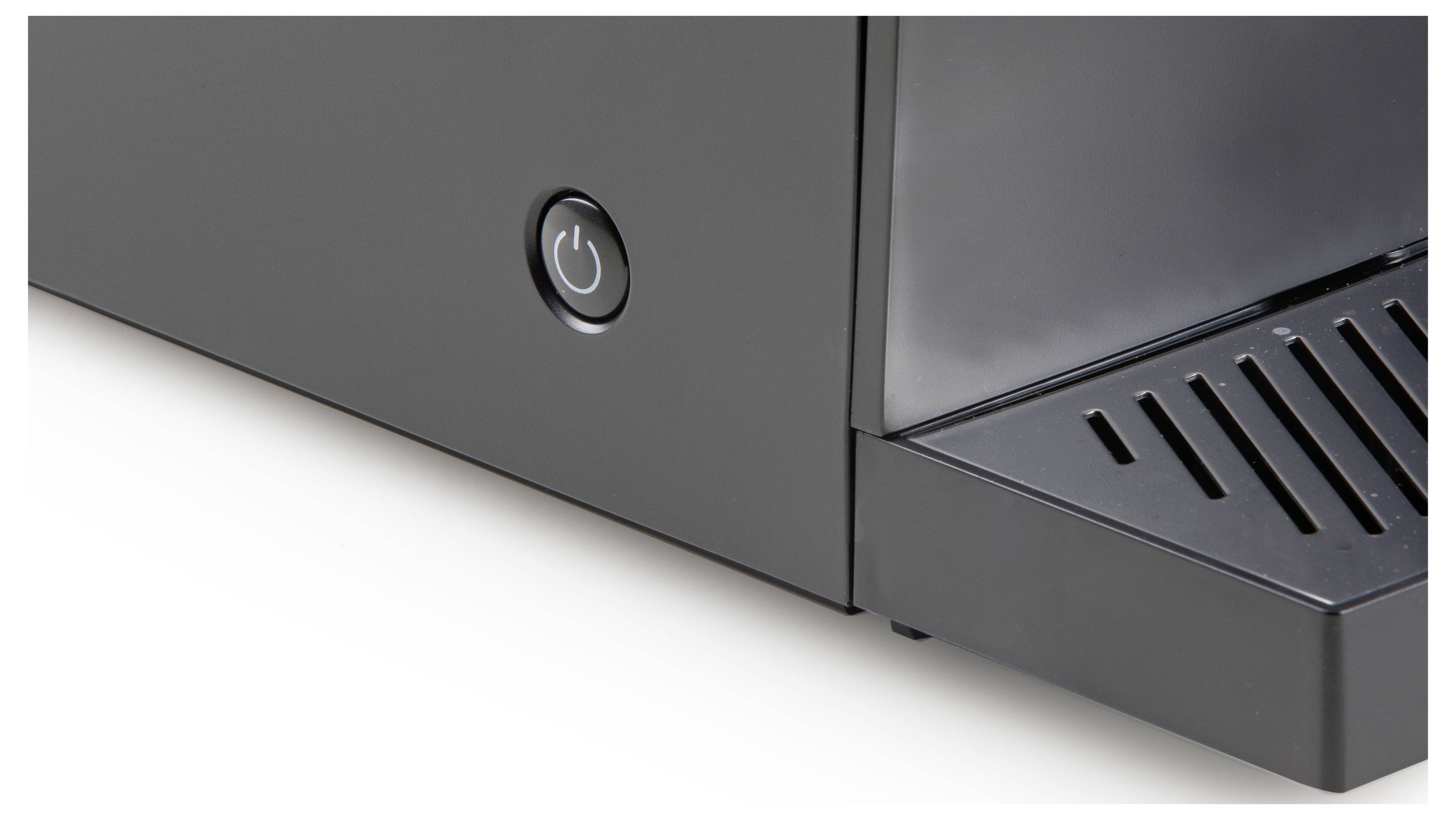 A part of a coffee machine is visible, with an inactive on/off switch and a drip tray on the right side.