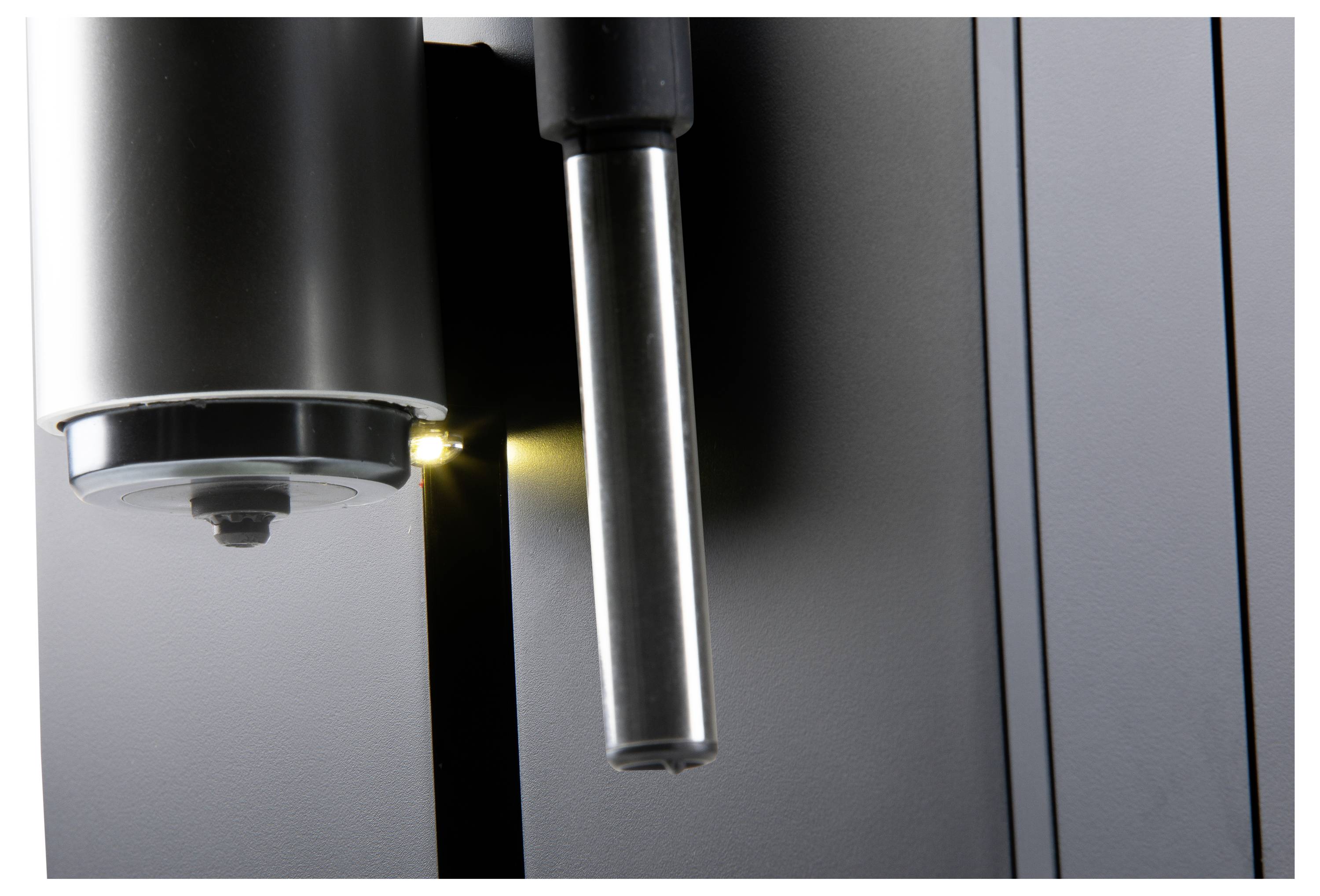 A close-up image of a metal machine with a cylindrical component reflecting light. Focus on material and texture.