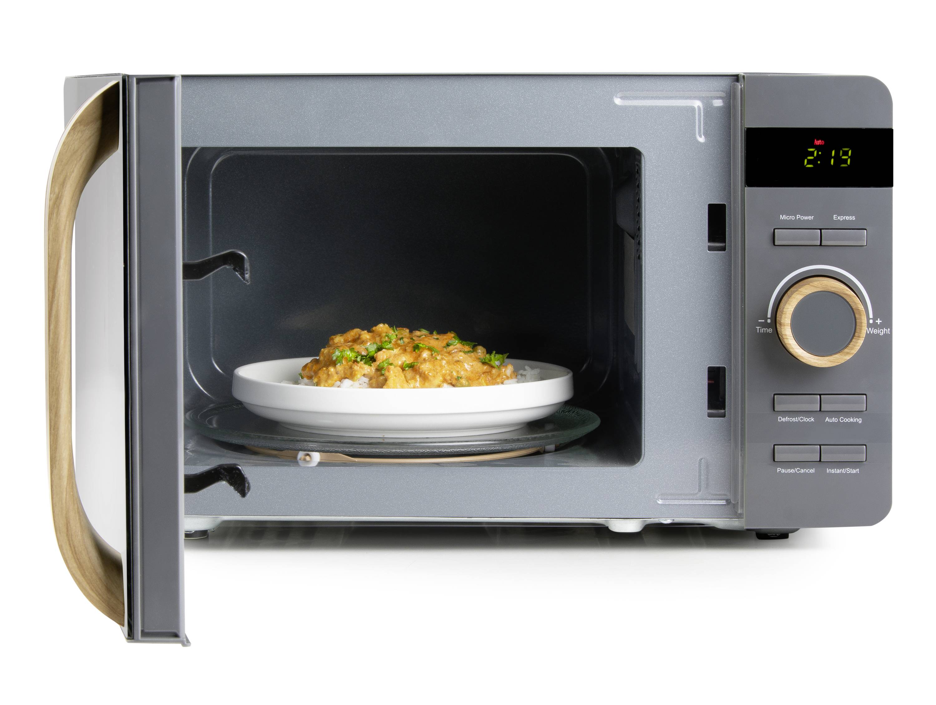 A microwave with an open door shows a plate of food inside. The display shows the time 2:19. Control panel with buttons on the right.