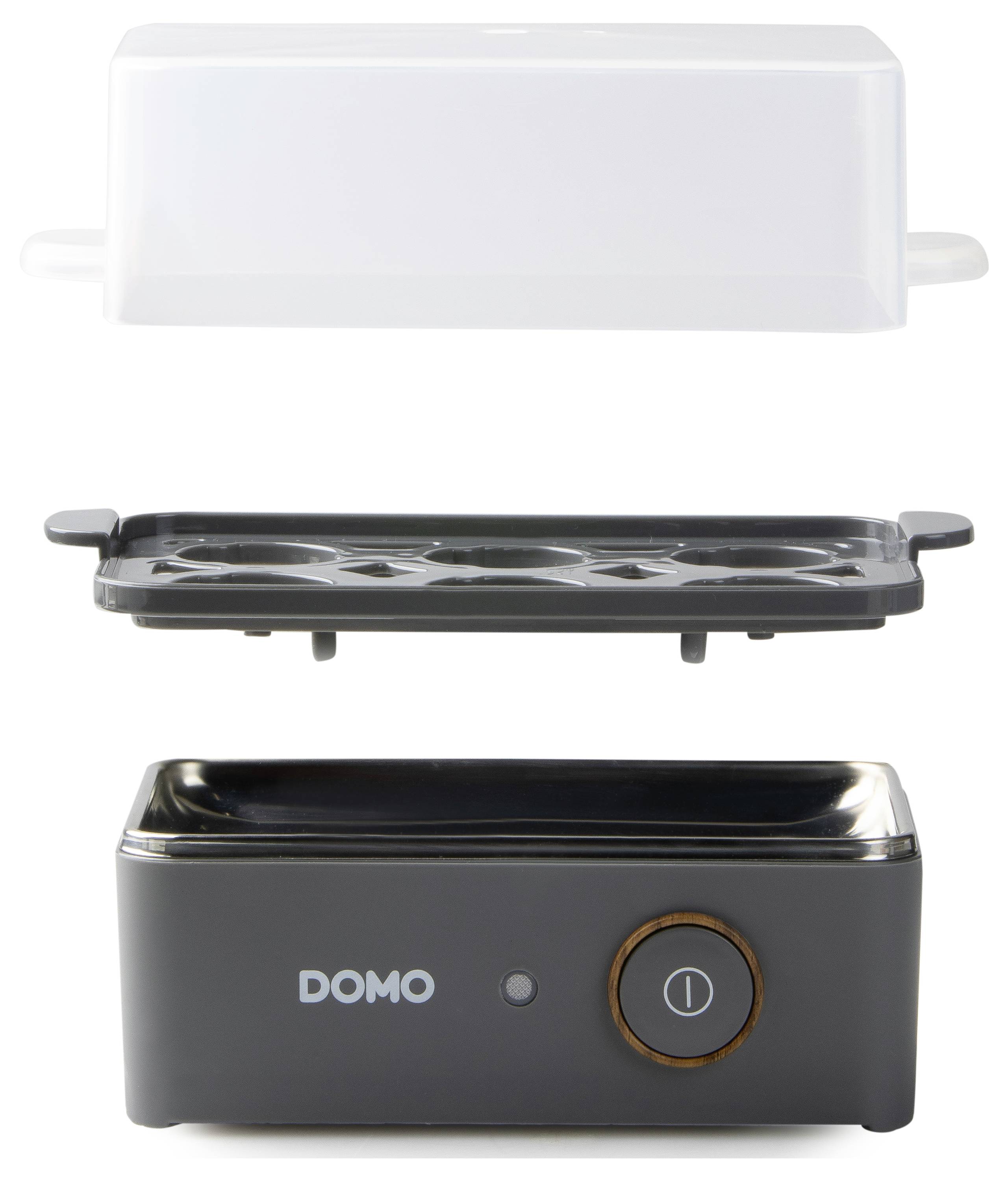 A compact egg cooker with three parts: lid, egg holder with space for six eggs, and base with switch. Brand: DOMO.