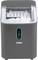A compact, grey ice maker with a transparent lid, filled with ice cubes. Front side displays a water level indicator.