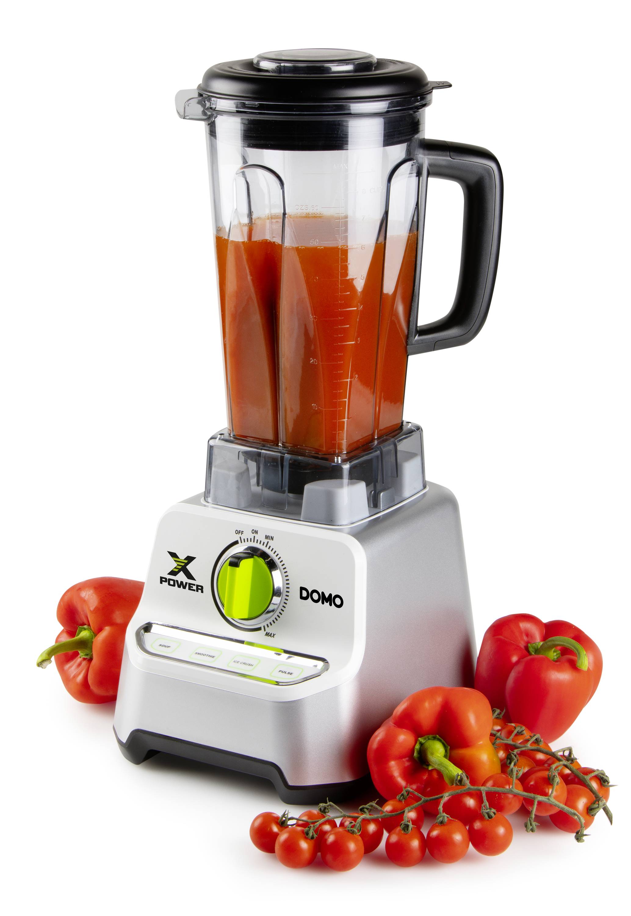 A blender stands on a white surface, filled with red juice. Around it are red peppers and tomatoes, representing the mixing ingredients.