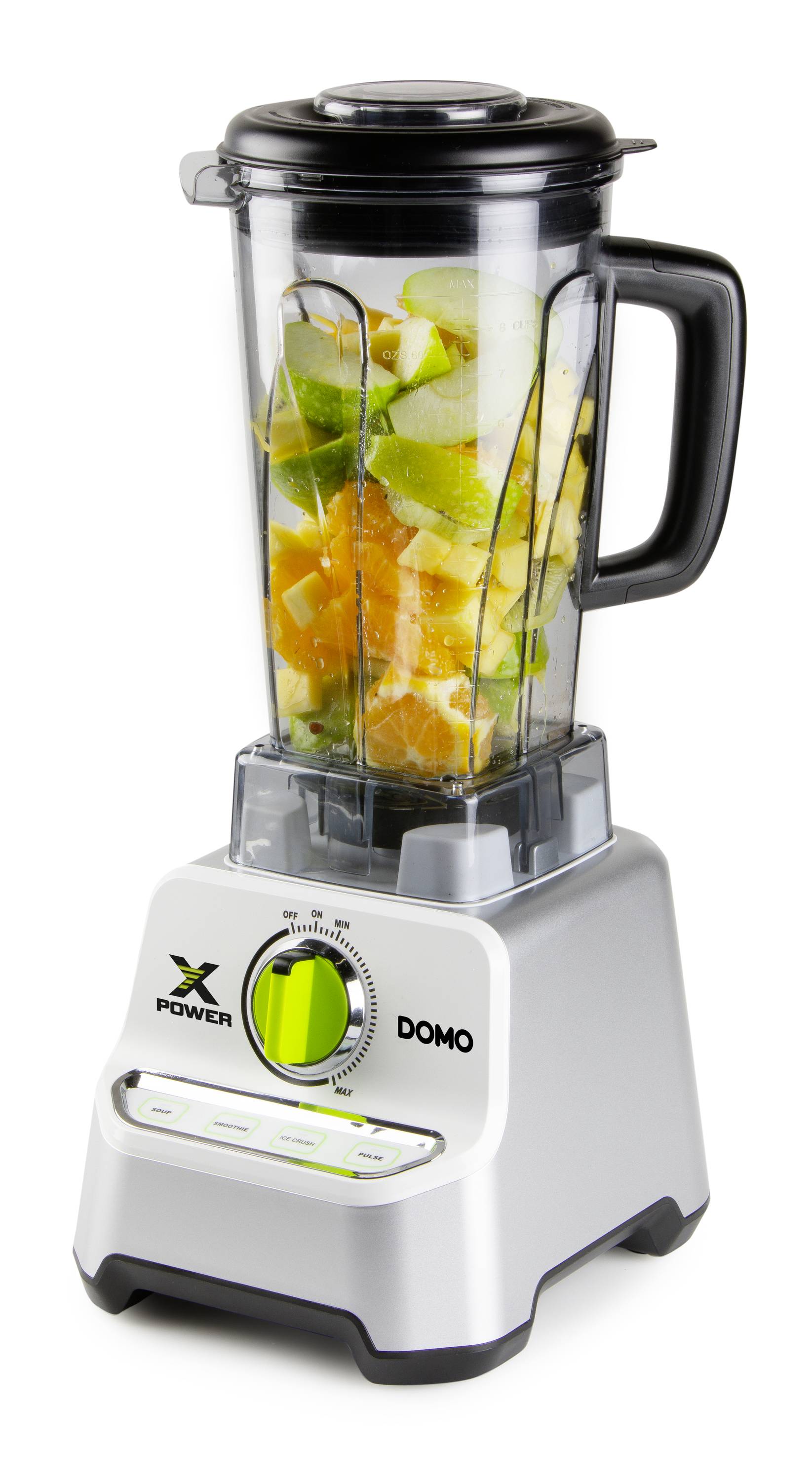 A grey blender with a measuring jug filled with colourful fruit pieces, including green apples and oranges. The blender is sitting on a white surface.
