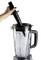 A hand is holding a muddler and pressing it into a blender filled with ice cubes. The blender has a black lid.