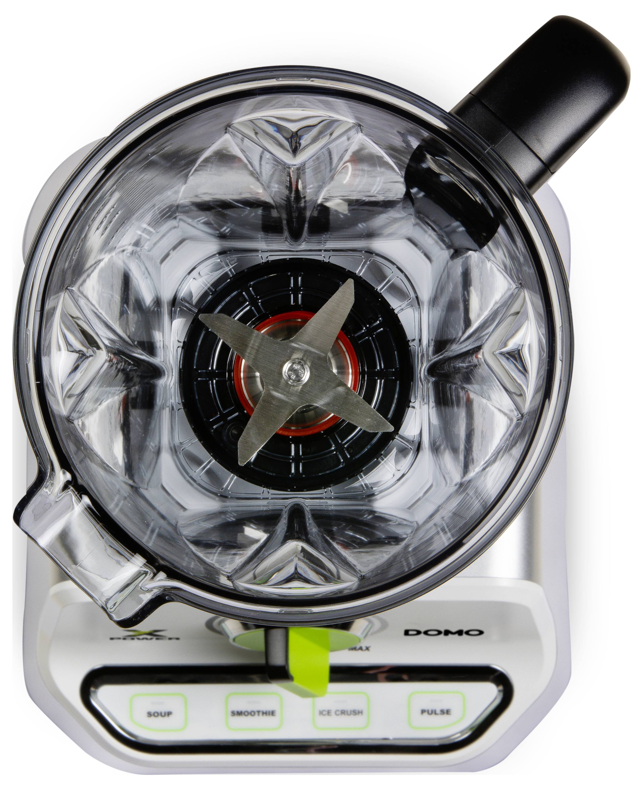 Mixer viewed from above, with the lid open. The four blades inside and the control buttons on the front are visible.