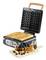 Waffle iron with two golden-brown waffles, alongside a wooden board with finished waffles, blueberries, and chocolate sauce.