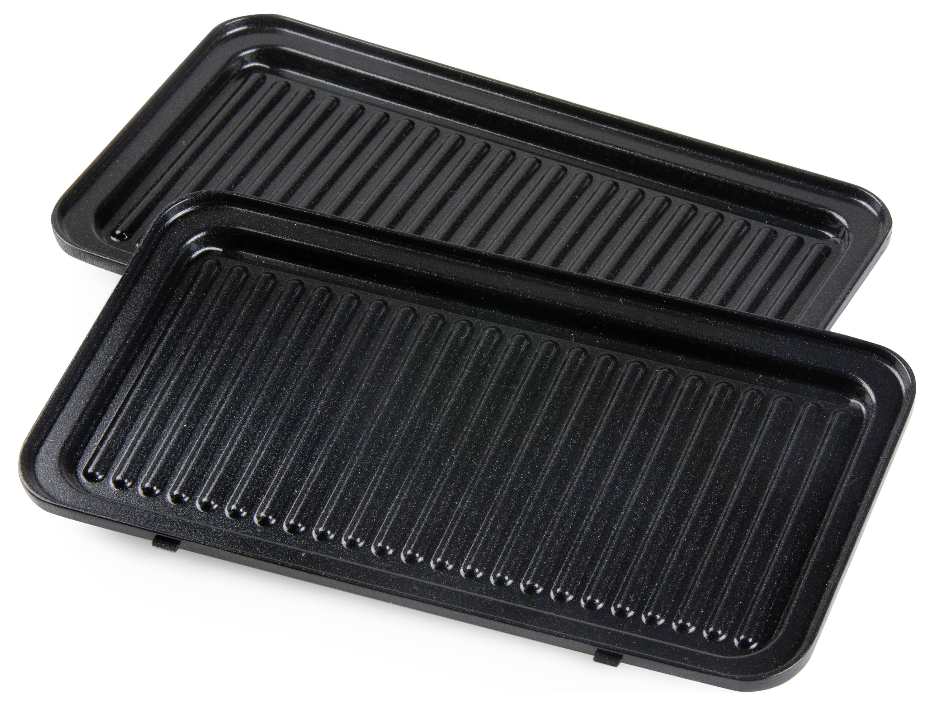 Two black, rectangular grill plates with ridged surfaces are stacked on top of each other on a white surface.