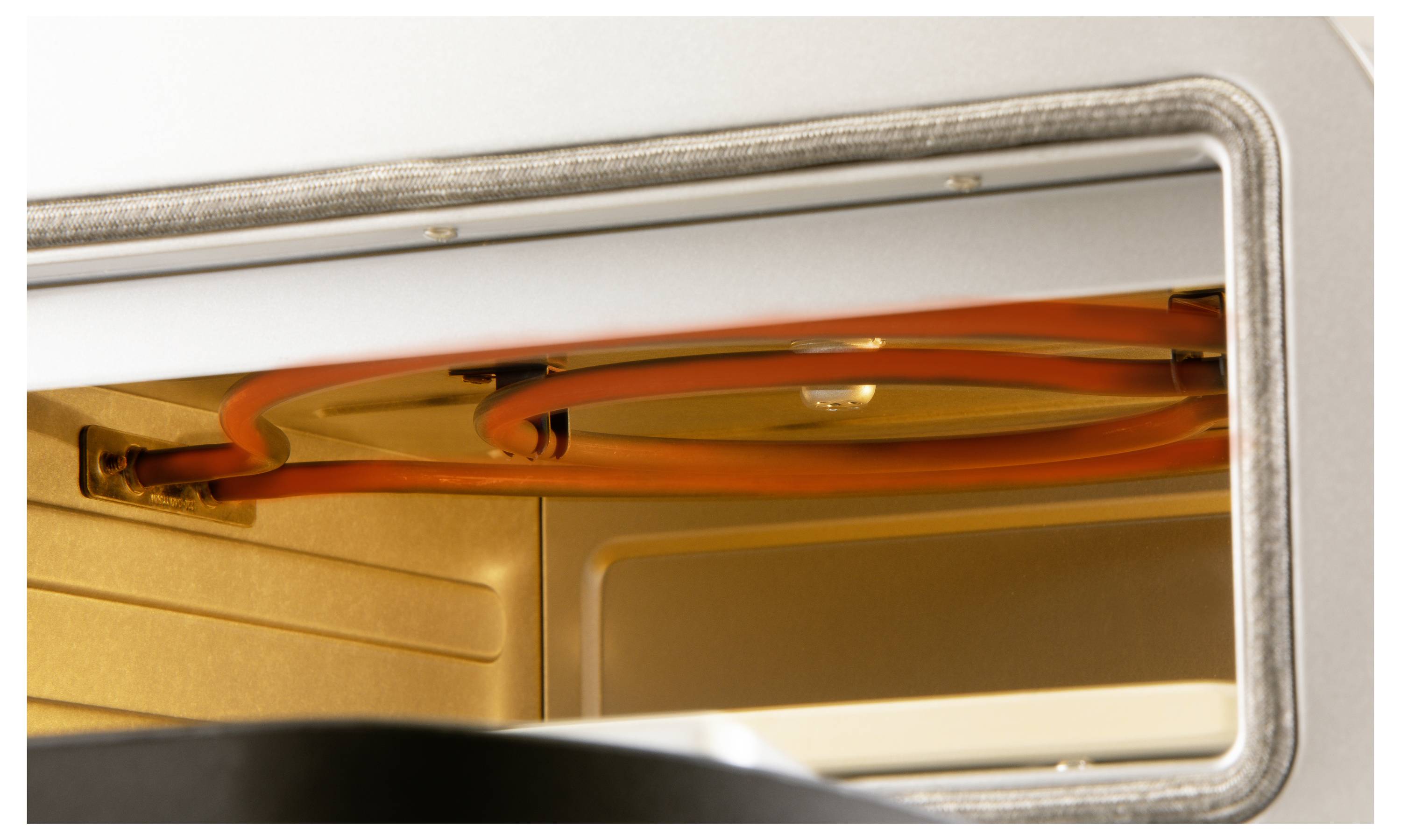 Close-up of an illuminated oven with visible heating element.