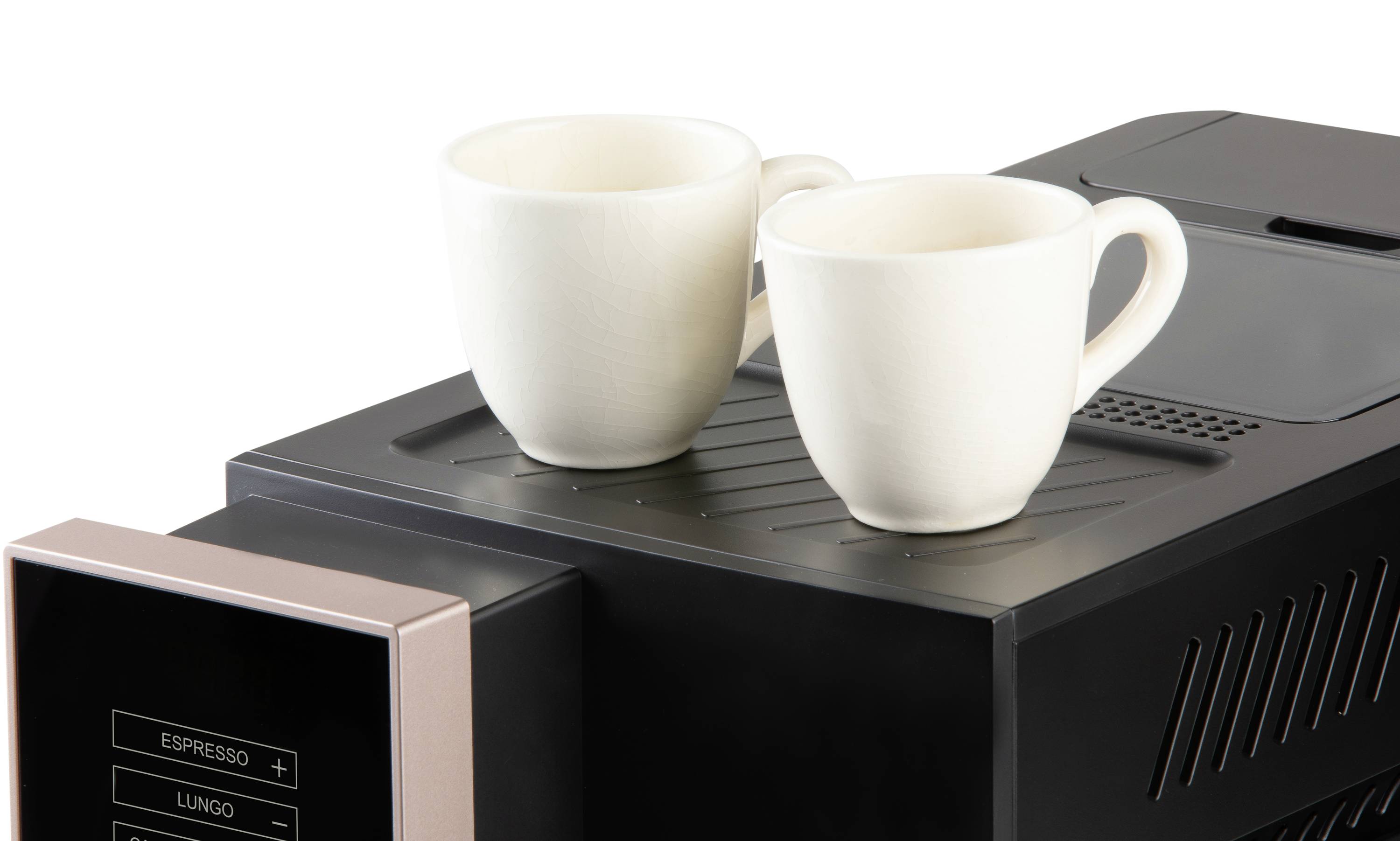 Two white coffee cups are sitting on the surface of a black espresso machine.