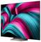 A large, modern flat-screen TV displaying a vibrant abstract image with swirling waves of pink and teal against a black background.