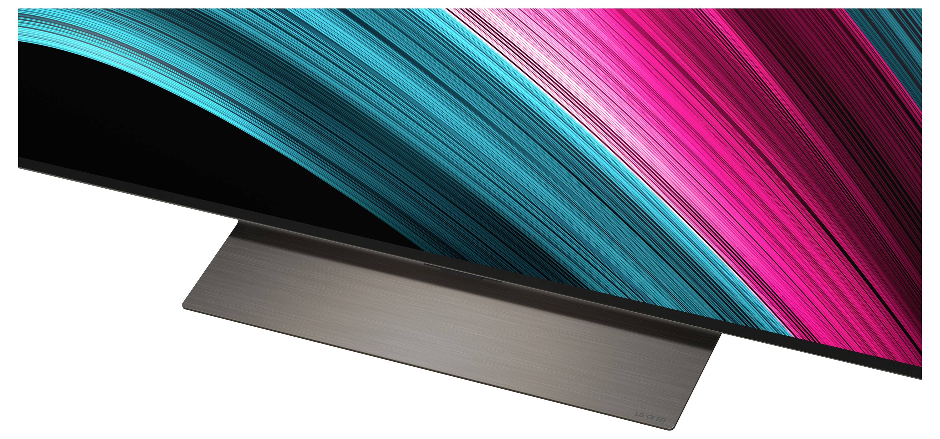 A sleek, modern monitor with a minimalist stand displaying vibrant teal and magenta diagonal light streaks on the screen.