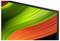 The image shows the corner of a computer monitor displaying a vibrant green and orange abstract wave pattern.