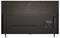 The image shows the back view of a black LG OLED television, featuring various ports and a power switch on the right side.