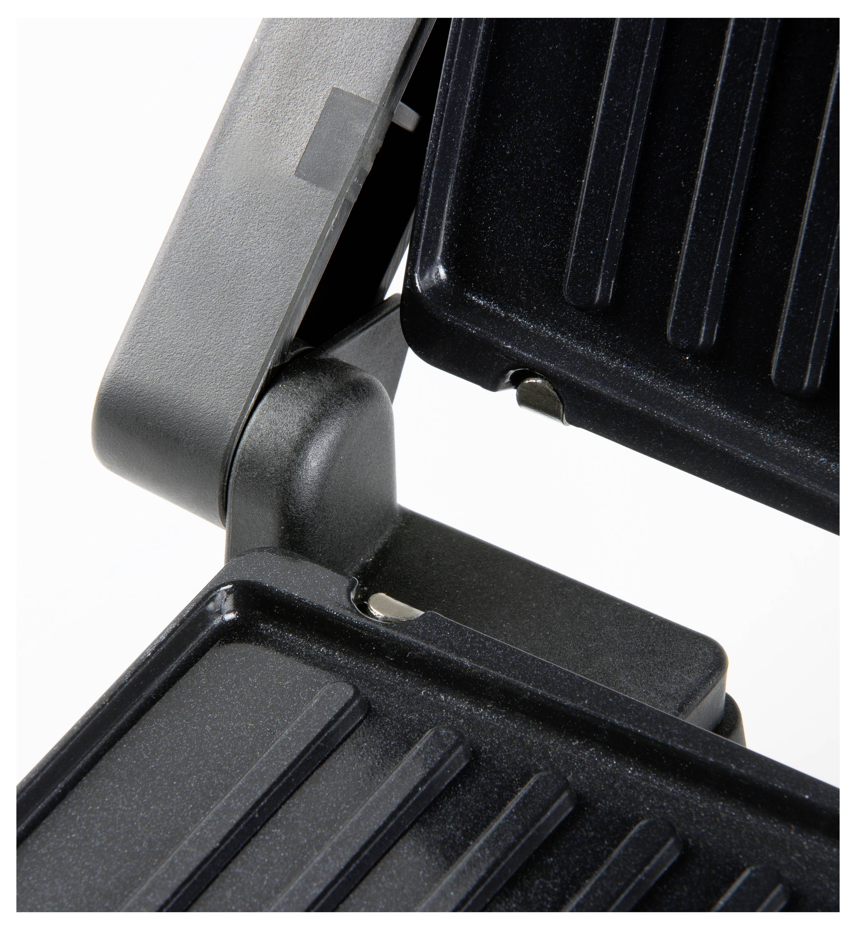 Close-up of a black grill with ridged plates that are closed. Suitable for grilling or toasting food.