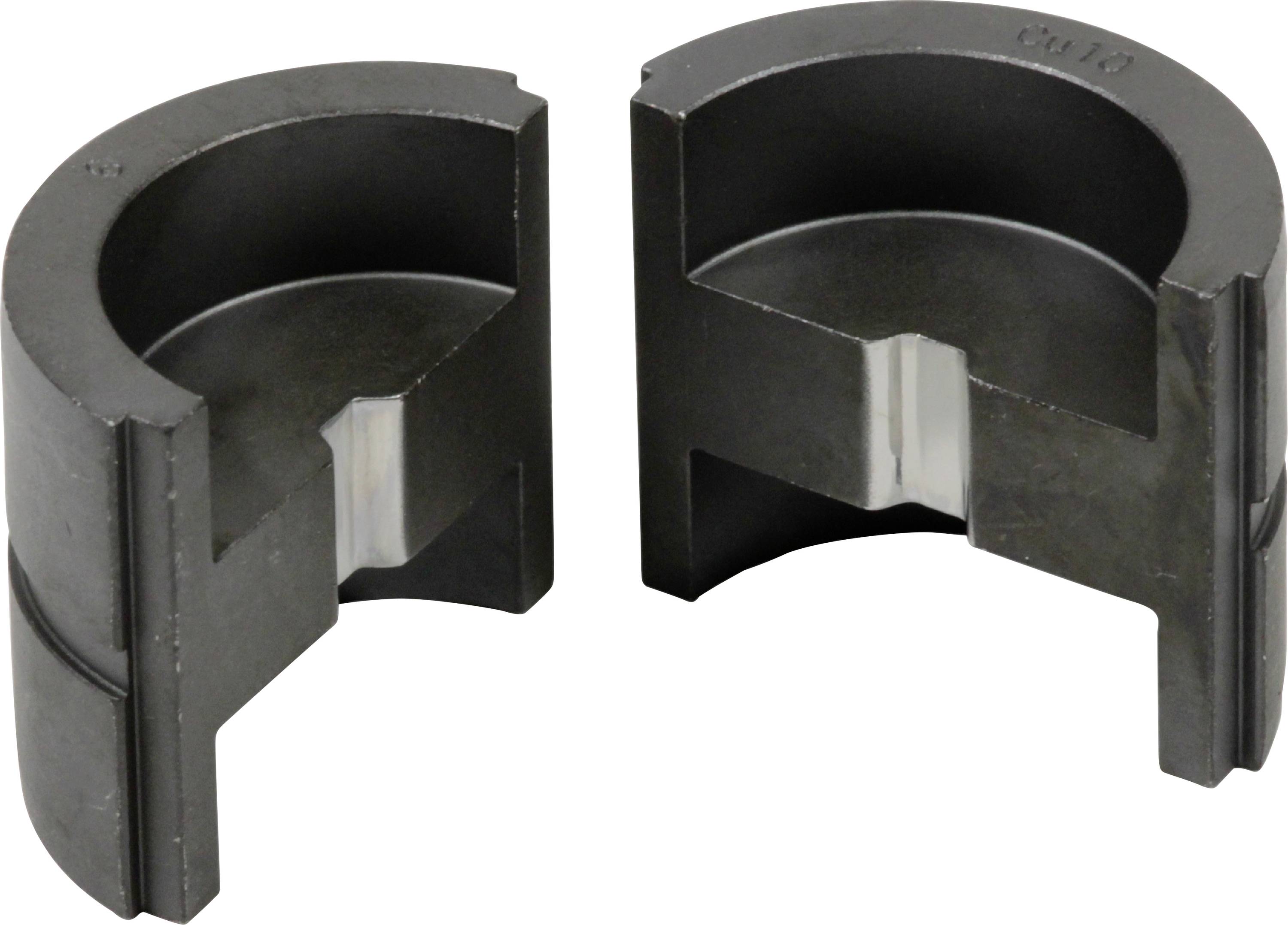 Two semi-circular metallic objects that look like split cylinders, with a notch and a lighter inner surface.